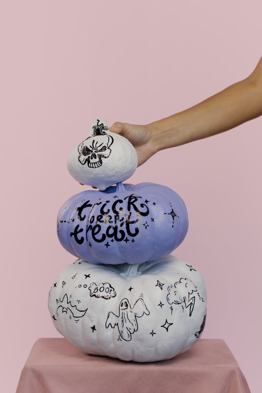 hand holding painted pumpkins