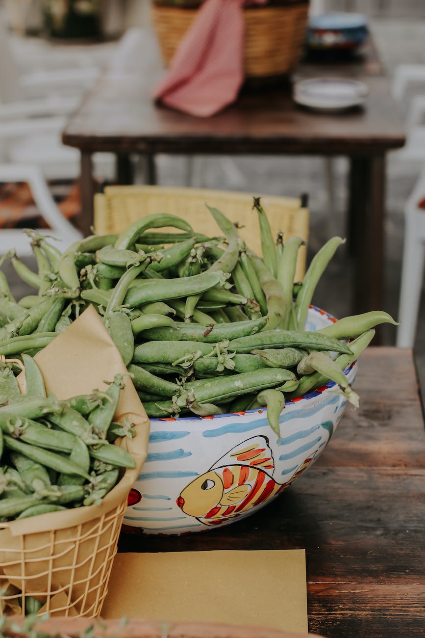 fresh green beans on a bowl